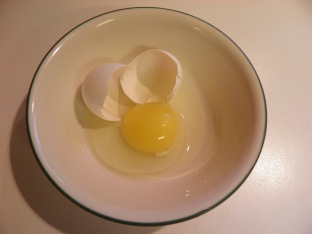 Broken Egg in a Bowl with its Eggshell